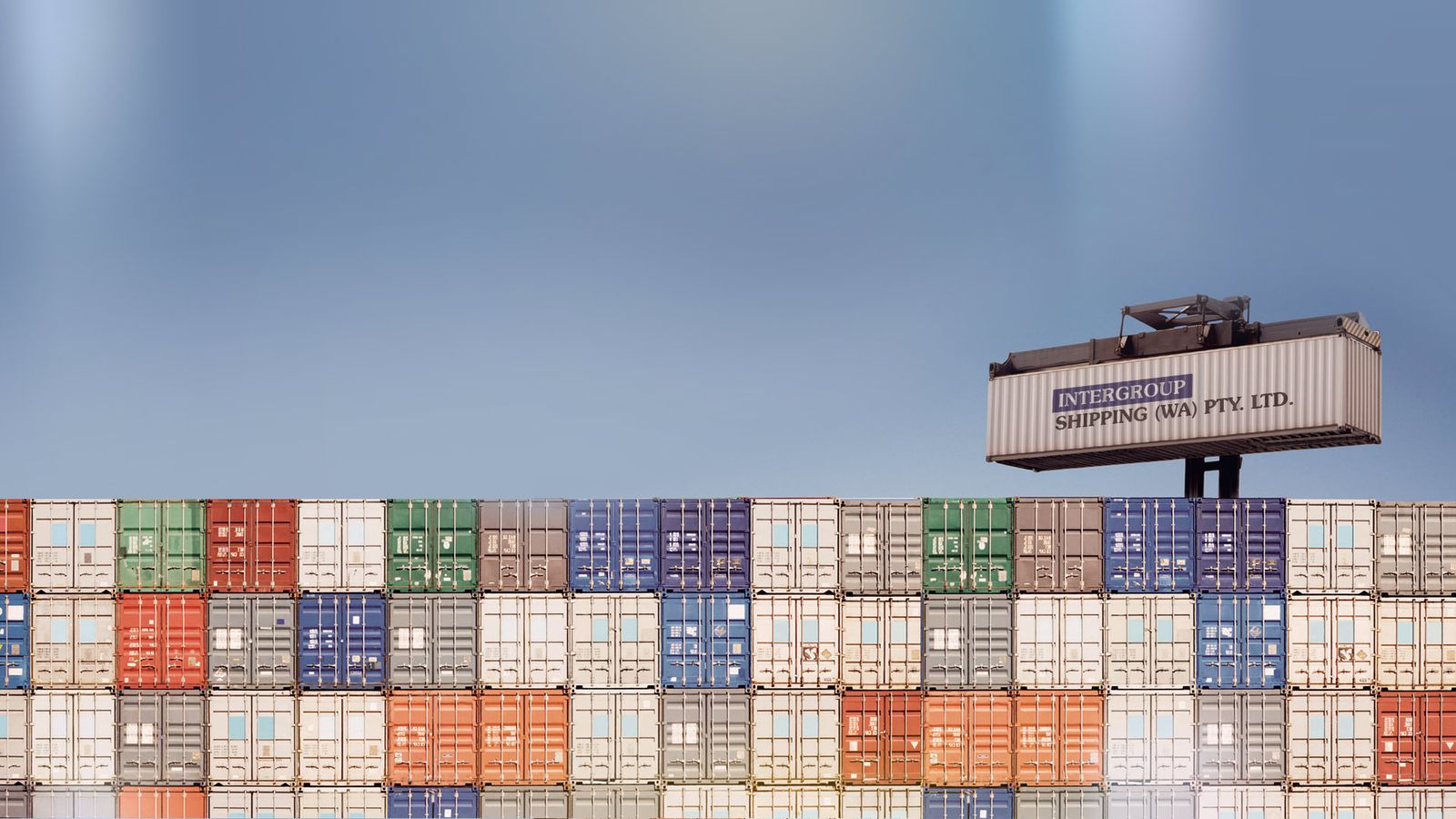 Intergroup Shipping container being lifted above stacked containers
